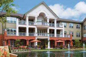 Image of the entrance of the Gatesworth, showcasing the patios, ponds, and luxury associated with this retirement facility